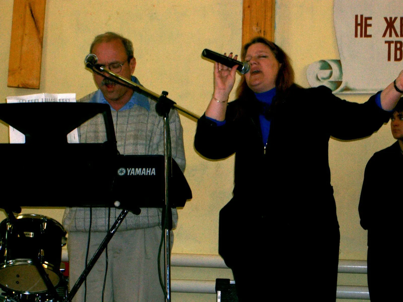 Paul at the keyboard and Loring singing, leading worship in a Russian church.